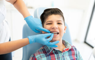 Kid in early orthodontic treatment getting his braces checked